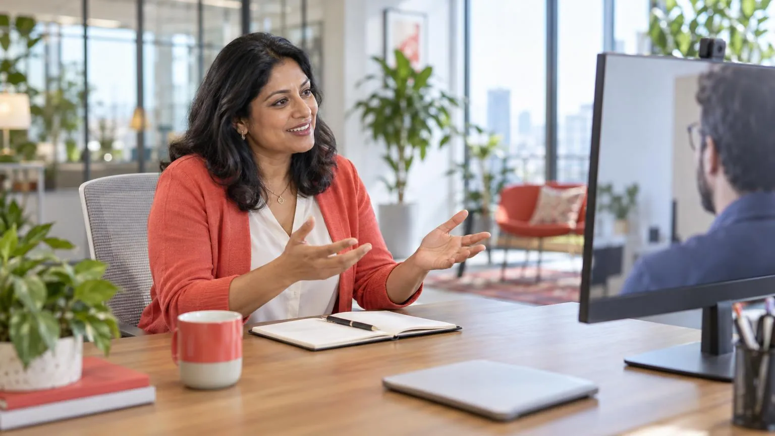A consultant explaining something on a video call from a bright modern office